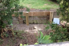 Log posts rammed into ground retaining wall - RD-W31