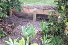 Log posts rammed into ground retaining wall - RD-W32